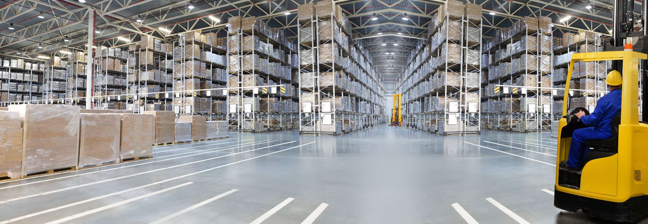 Huge,Distribution,Warehouse,With,High,Shelves,And,Loaders.,Bottom,View.